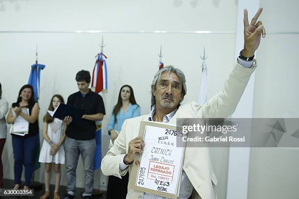 Relative of disappeared railway worker Juan Carlos Catnich gestures during the delivery of repaired files to the descendants of 20 disappeared...