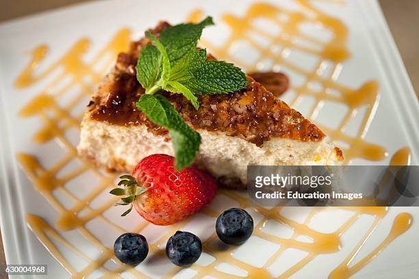 Cheesecake on white plate with caramel sauce, David's Restaurant, Amelia Island, FL.