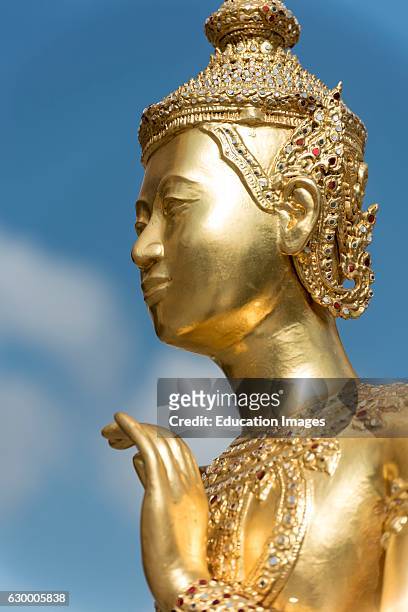 Golden statue of mythical deity Kinnorn, Kinnara at Wat Phra Kaew Temple, Grand Palace, Bangkok, Thailand.