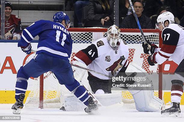 Toronto Maple Leafs center Zach Hyman tries to swipe the puck by Mike Smith as the Toronto Maple Leafs lose to the Arizona Coyotes in shootout at the...