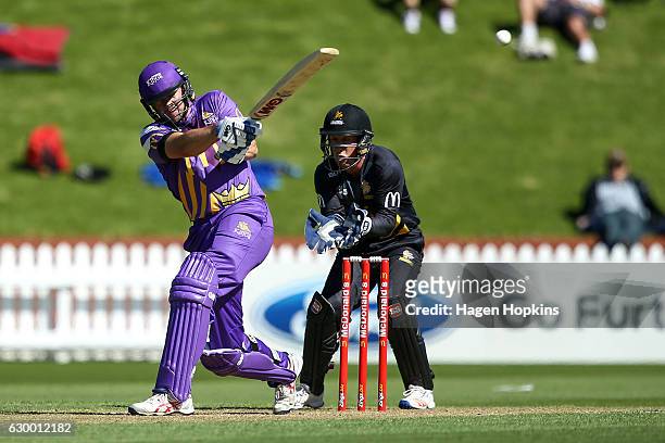 Peter Fulton of the Kings bats while Luke Ronchi of the Firebirds looks on during the McDonalds Super Smash T20 match between Wellington Firebirds...