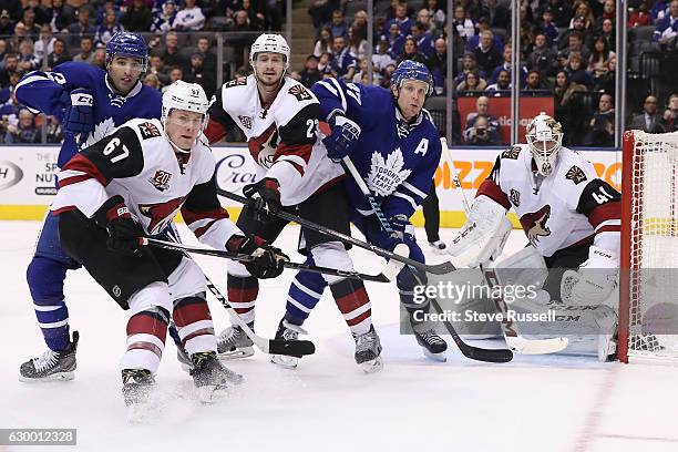 Nazem Kadri, Lawson Crouse, Oliver Ekman-Larsson, Leo Komarov, and Mike Smith wait for the puck to come out of the corner as the Toronto Maple Leafs...