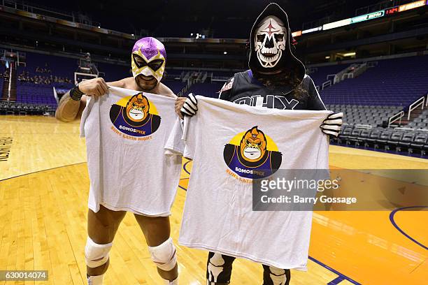 Wrestlers, El Hijo Del Fantasma and La Parka pose for a picture before the game between the Phoenix Suns and the San Antonio Spurs on December 15,...