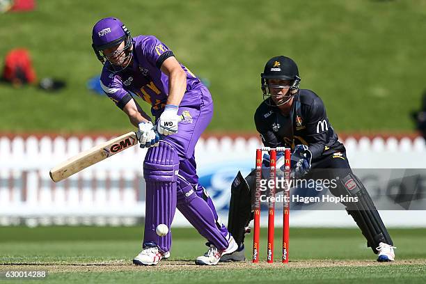 Peter Fulton of the Kings bats while Luke Ronchi of the Firebirds looks on during the McDonalds Super Smash T20 match between Wellington Firebirds...