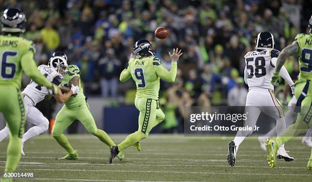 Punter Jon Ryan of the Seattle Seahawks bobbles the ball on a run against the Los Angeles Rams at CenturyLink Field on December 15, 2016 in Seattle,...