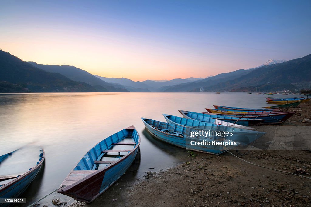 Beautiful twilight landscape with boats on Phewa lake, Pokhara, Nepal.