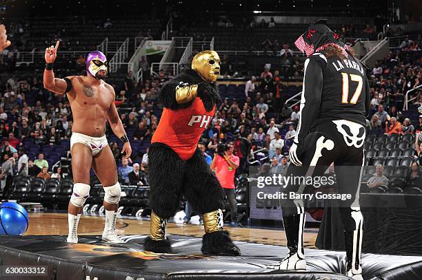 Wrestlers El Hijo Del Fantasma and La Parka attend Latin Night with the Phoenix Suns during the game against the San Antonio Spurs on December 15,...