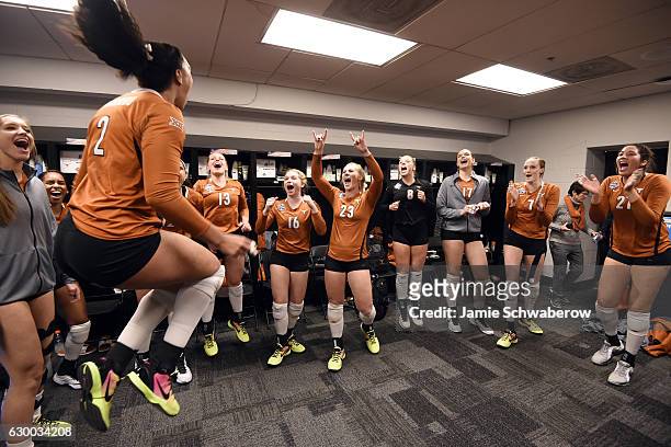 Ebony Nwanebu of the University of Texas celebrates with teammates after their win over Nebraska in the Division I Women's Volleyball Semifinals held...