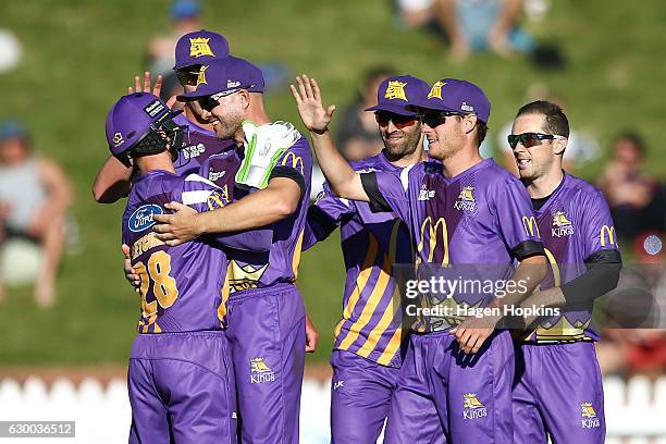 Cameron Fletcher of the Kings is congratulated by teammate Peter Fulton after dismissing Luke Ronchi of the Firebirds during the McDonalds Super...