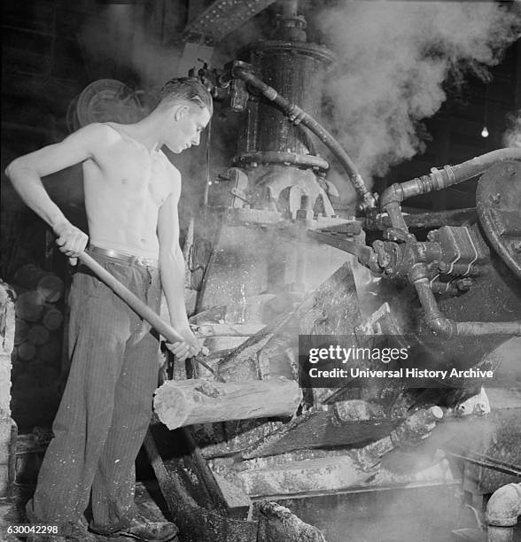 Worker at Machine that Grinds Wood into Pulp, Mississquoi Corporation Paper Mill, Sheldon Springs, Vermont, USA, by Jack Delano for Farm Security...