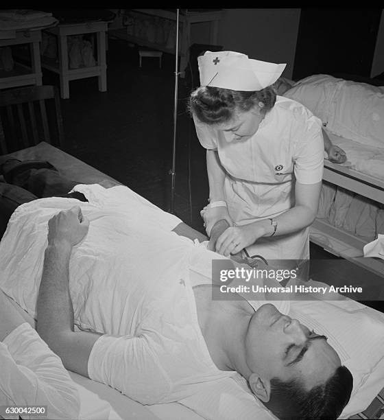 Fireman Giving Pint of Blood to Red Cross, New York City, New York, USA, Marjorie Collins for Office of War Information, January 1943.