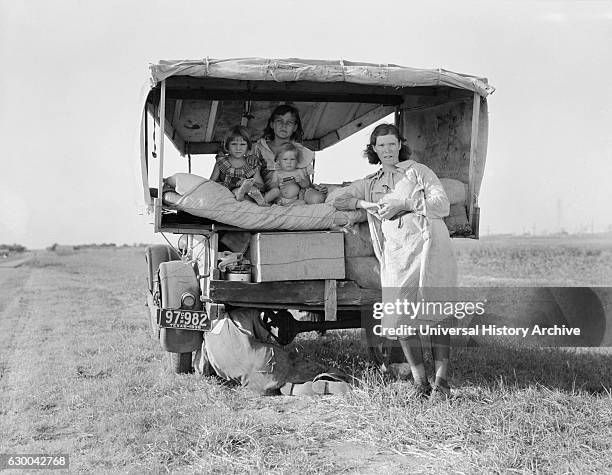 Migrant Family Heading to Arkansas Delta for Work in Cotton Fields, with Flat Tire, Texas, USA, Dorothea Lange for Farm Security Administration,...