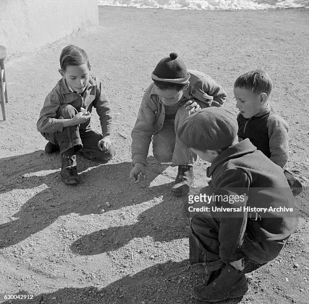 Children Playing Marbles, Trampas, New Mexico, USA, John Collier for Office of War Information, January 1943.