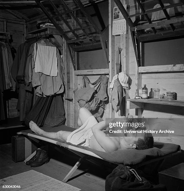 Enlisted Man in Barracks Playing Flute after Taking Shower, Air Service Command, Greenville, South Carolina, USA, by Jack Delano for Office of War...