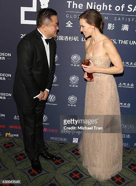 Hilary Swank and Dong Geng attend the 21st Annual Huading Global Film Awards - press room held at The Theatre at Ace Hotel on December 15, 2016 in...