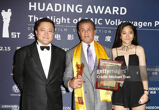Dong Geng with Sylvester Stallone attend the 21st Annual Huading Global Film Awards - press room held at The Theatre at Ace Hotel on December 15,...