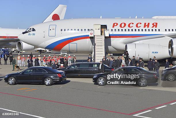 Security guards stand close the car of Russian President Vladimir Putin who just arrived in Tokyo Haneda Airport, Japan on December 16, 2016....