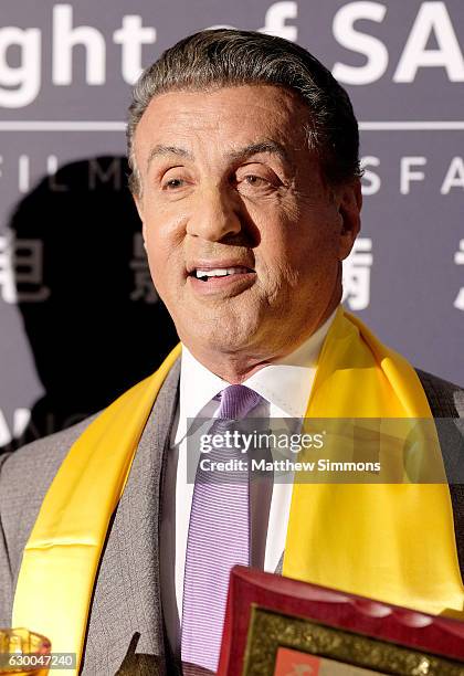 Actor Sylvester Stallone poses in the press room at the 21st Annual Huading Global Film Awards at The Theatre at Ace Hotel on December 15, 2016 in...