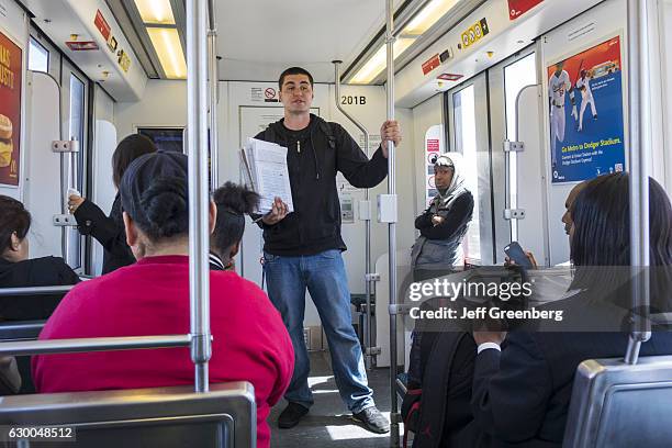 Man on a train gathering signatures for a petition.