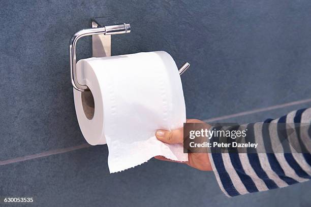 child pulling toilet roll - papel higiénico fotografías e imágenes de stock