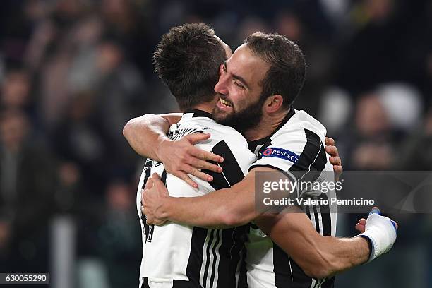 Gonzalo Higuain of Juventus celebrates after scoring the opening goal with team mate Mario Mandzukic during the UEFA Champions League Group H match...