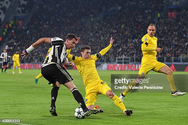 Mario Mandzukic of Juventus is challenged by Josip Pivaric of GNK Dinamo Zagreb during the UEFA Champions League Group H match between Juventus and...