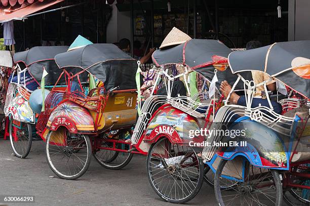 becak bicycle rickshaw pedicabs - yogyakarta stock pictures, royalty-free photos & images