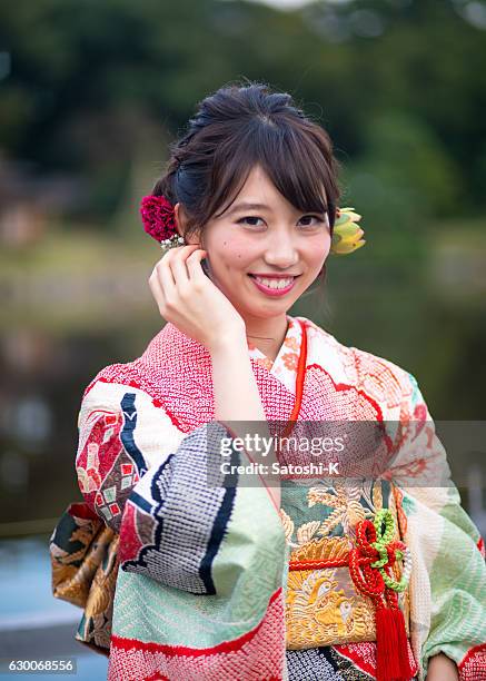 portrait of young furisode girl in garden - seijin no hi stock pictures, royalty-free photos & images