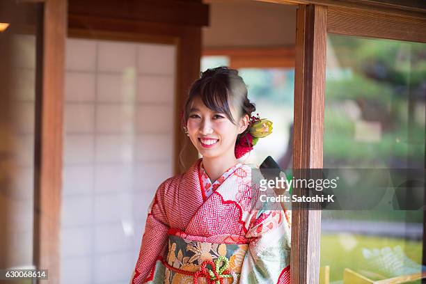 young furisode girl walking in japanese house - seijin no hi stock pictures, royalty-free photos & images