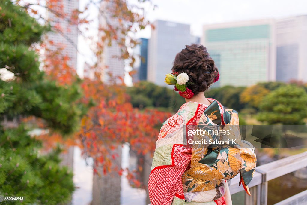 Young Furisode girl in autumn garden