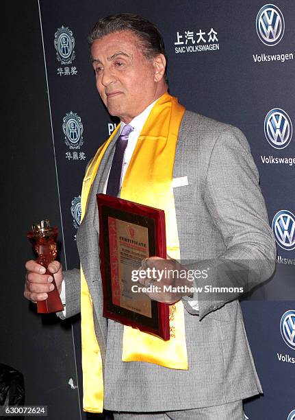 Actor Sylvester Stallone poses in the press room at the 21st Annual Huading Global Film Awards at The Theatre at Ace Hotel on December 15, 2016 in...