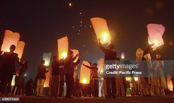 Pakistani civil society activists and Media foundation workers release lanterns in the sky as they pay tribute to victims of Army Public School...