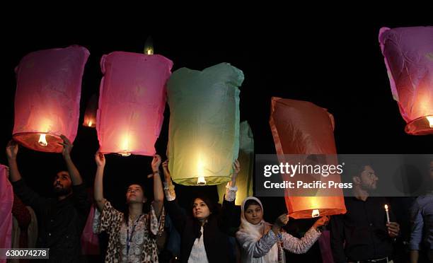 Pakistani civil society activists and Media foundation workers release lanterns in the sky as they pay tribute to victims of Army Public School...