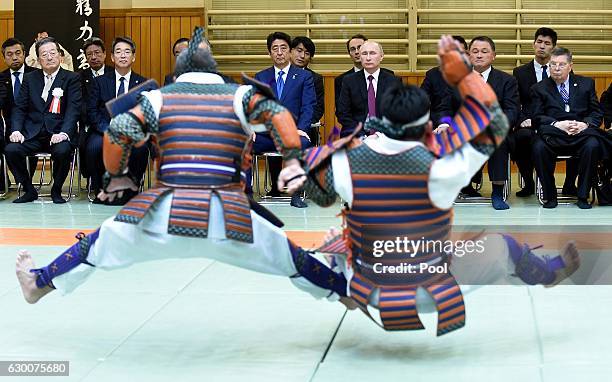 Russian President Vladimir Putin and Japanese Prime Minister Shinzo Abe look at performance of ancient custom judo beside Vice Chairman of the All...