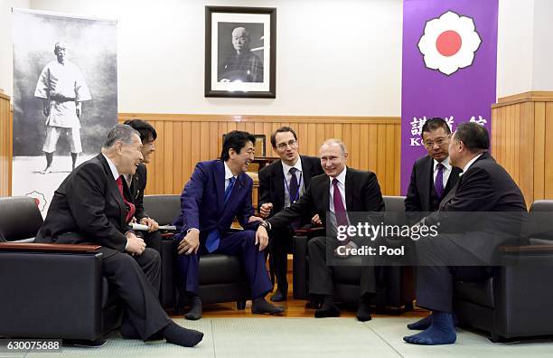 Russian President Vladimir Putin chats with Japanese Prime Minister Shinzo Abe , former Japanese Prime Minister Yoshiro Mori and Vice Chairman of the...