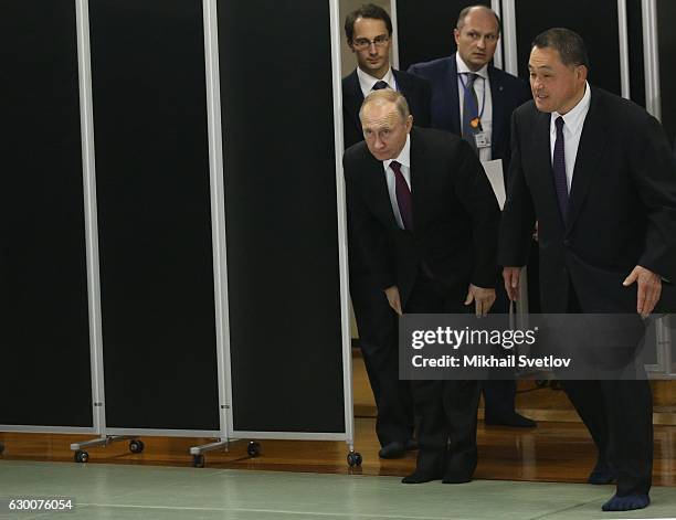 Russian President Vladimir Putin and Gold Olympic medalsit Yasuhiro Yamashita greet athlets as he is visiting the Kodokan Judo Institute on December...