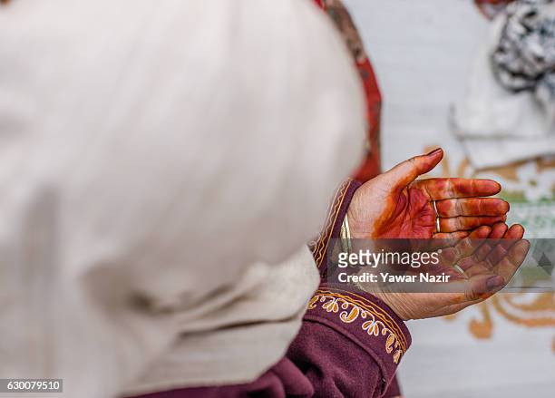Kashmiri Muslim woman prays, at Hazratbal shrine on the Friday following Eid-e-Milad , or the birth anniversary of Prophet Mohammad on December 16,...