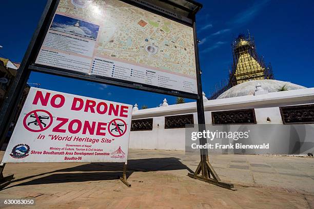 Signpost with the warning No Drone Zone at the Bouda Stupa, rebuilt after beeing damaged during 2015 earthquake.
