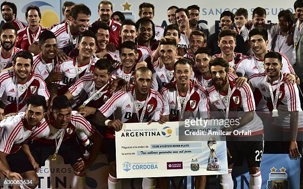 Players of River Plate pose holding a giant check after a final match between River Plate and Rosario Central as part of Copa Argentina 2016 at Mario...