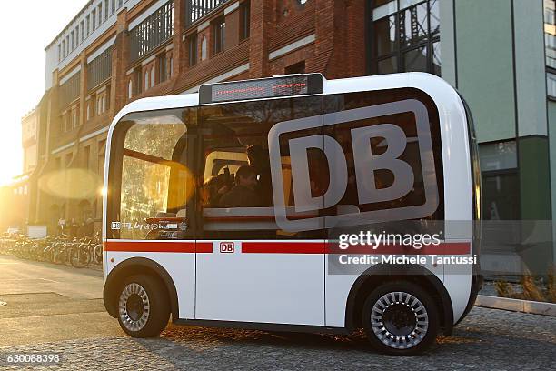 German Transport Minister Alexander Dobrindt and Deutsche Bahn head Ruediger Grube sit in a self driving Bus during the presentation of a pilot...