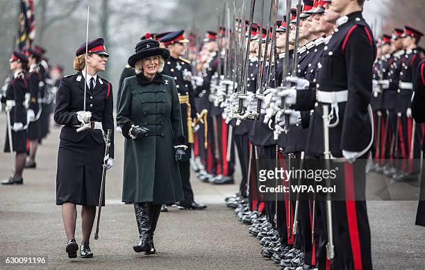 Camilla, Duchess of Cornwall inspects graduating officer cadets alongside sword of honour recipient Rosie Wild during The Sovereign's Parade at Royal...