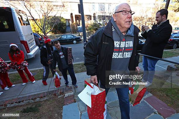 Mike Thibault of the Washington Mystics presents gifts to kids during the annual gift delivery trip around Washington D.C. To home of families on...