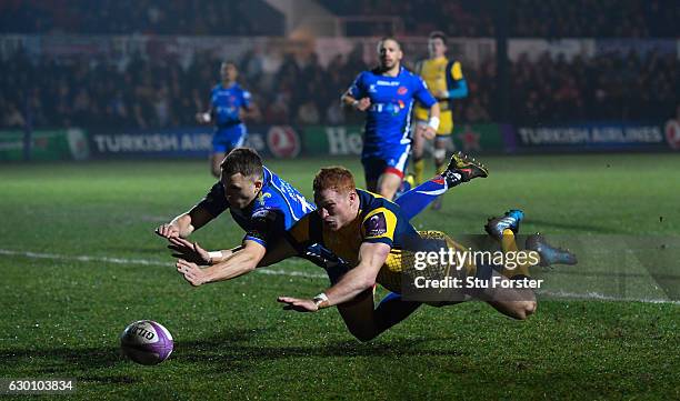 Warriors player Connor Braid dives to score the opening try during the European Rugby Challenge Cup match between Newport Gwent Dragons and Worcester...