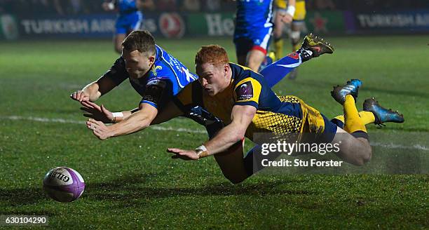 Warriors wing Connor Braid dives to beat Tom Prydie to score the opening try during the European Rugby Challenge Cup match between Newport Gwent...