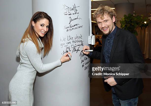 Amelie van Tass and Thommy Ten of The Clairvoyants sign the wall at AOL HQ when they visit for Build Presents The Clairvoyants Discussing the...