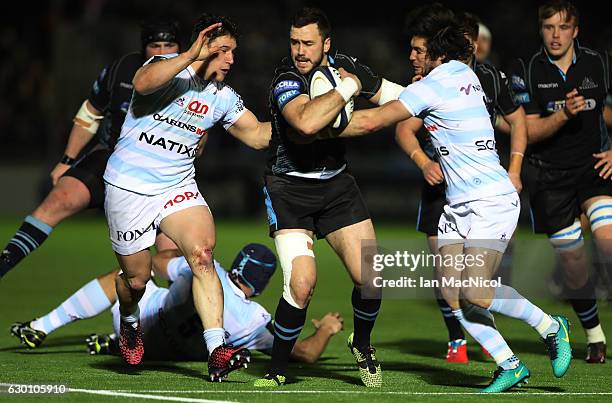 Alex Dunbar of Glasgow is tackled by Maxime Machenaud of Racing 92 during the European Rugby Champions Cup match between Glasgow Warriors and Racing...