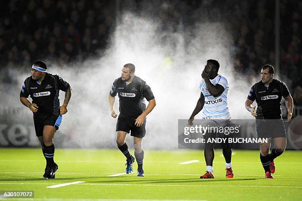 Players leave a fog of steam after a scrum during the European Champions Cup pool 1 rugby union match between Glasgow Warriors and Racing 92 at...
