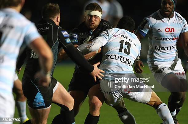 Alex Allan of Glasgow is tackled by Casey Laulala of Racing 92 during the European Rugby Champions Cup match between Glasgow Warriors and Racing 92...
