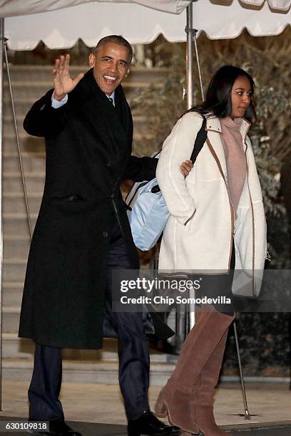 President Barack Obama and his daughter Sasha depart the White House before boarding Marine One on the South Lawn December 16, 2016 in Washington,...