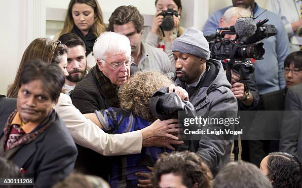 Woman needing medical care is helped by members of the media as President Obama holds a year-end press conference addressing email hacking and cyber...